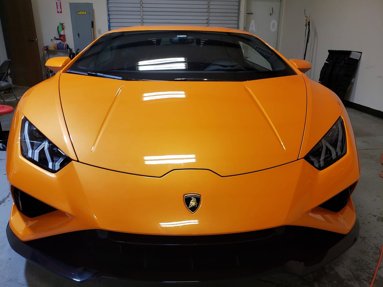 Orange Lamborghini Huracán EVO with deep gloss in the shop