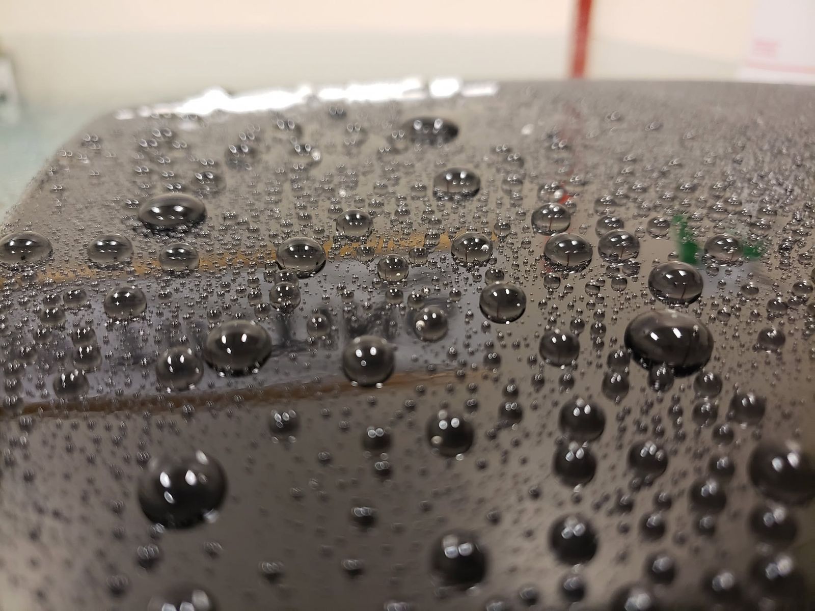 Dense water beading on coated black paint